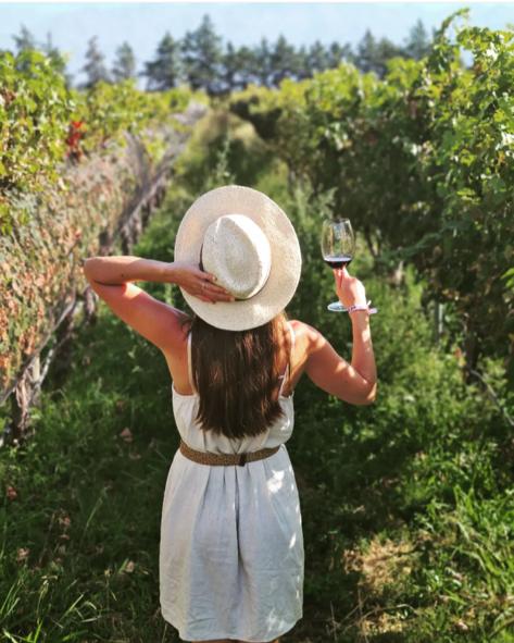 Woman in the vineyards with a glass of malbec wine in Mendoza Argentina